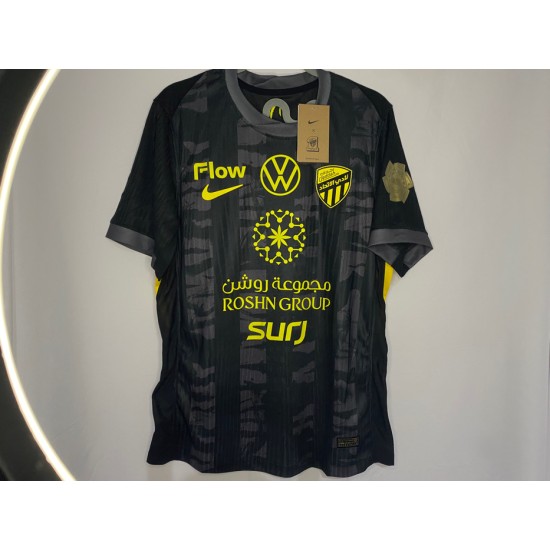Al-Ittihad black jersey with the Golden League logo + a free Al-Ittihad logo sticker.